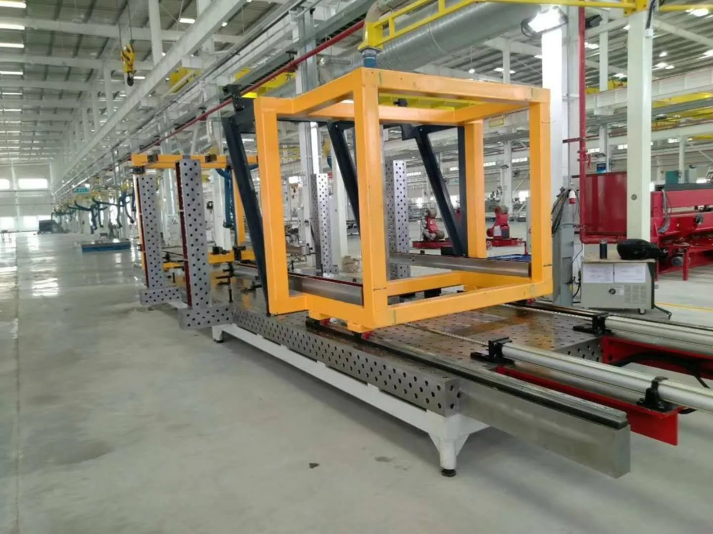 Compact welding workstation with a yellow fabricated workpiece and modular fixtures